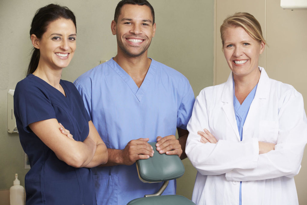 Dental practice workers smiling together